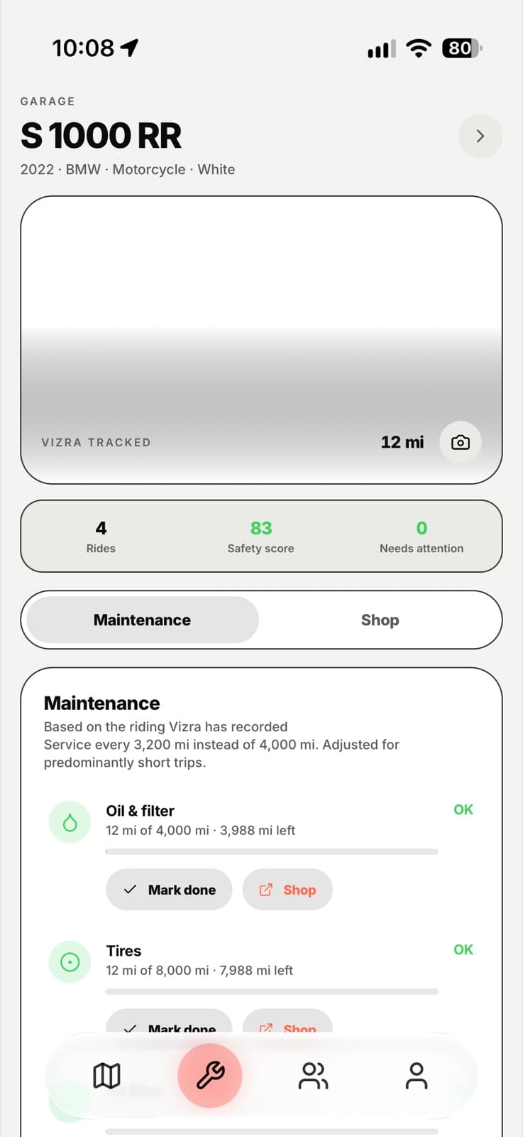 The garage showing a BMW S 1000 RR with rides, safety score and maintenance.